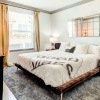 bedroom with a large window and modern decor