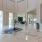 a large room with a large white tile floor and a large white table