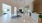 a large room with a large white tile floor and a large white table