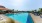 a swimming pool with a building in the background