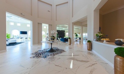 a large room with a large white tile floor and a large white table