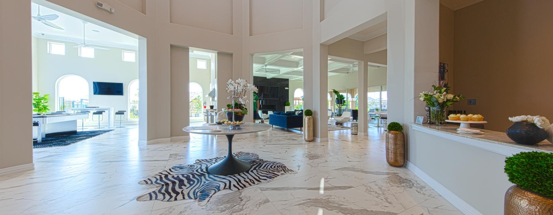 a large room with a large white tile floor and a large white table