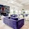 a living room with a large purple rug and a large window