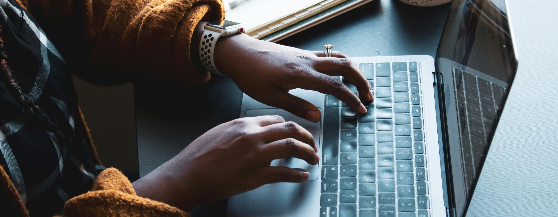 a person typing on a laptop