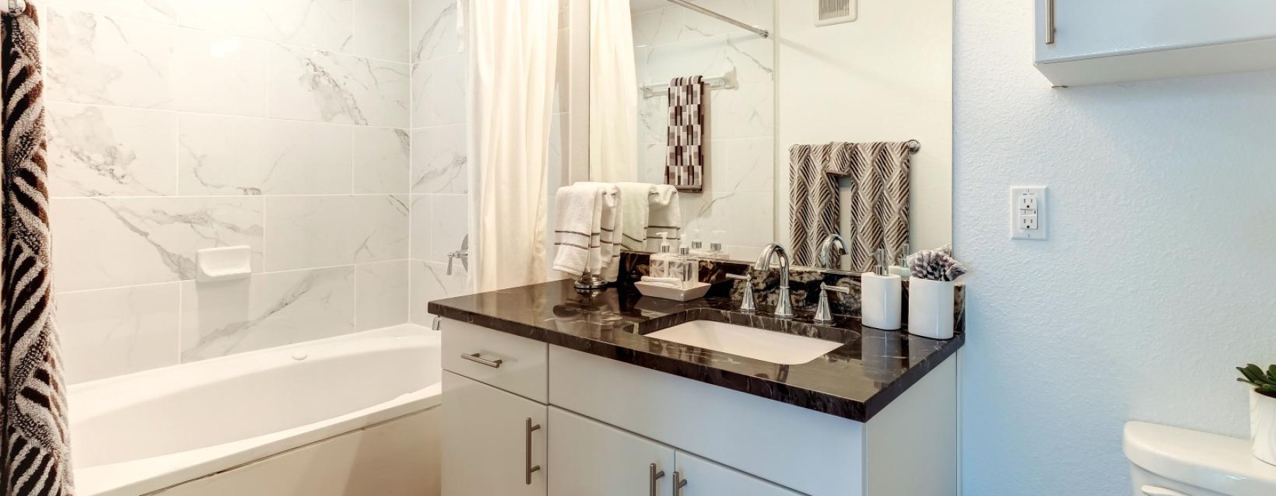 a bathroom with a tub sink and a mirror