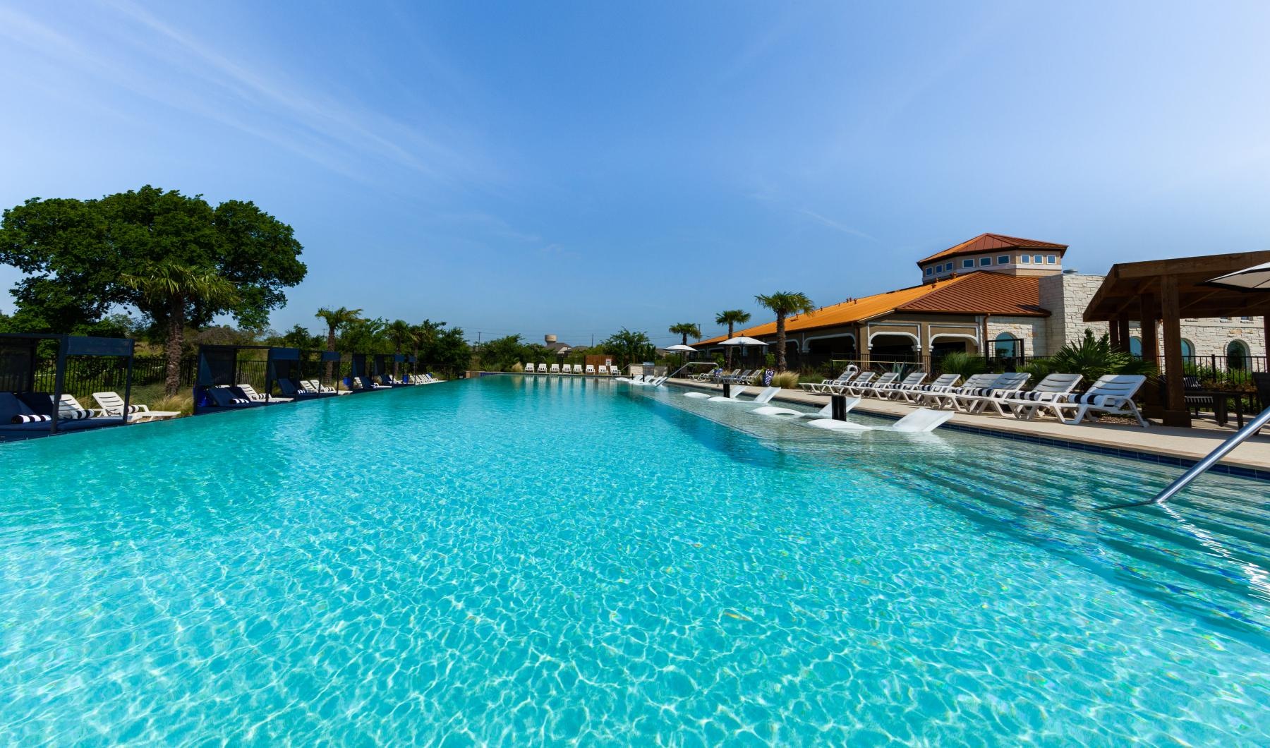 a swimming pool with lounge chairs