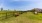 a grassy field with benches
